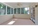 Cozy screened-in porch with wood flooring and large windows overlooking the serene backyard at 5148 Coolamber Dr, Powder Springs, GA 30127
