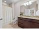 Bathroom with tile flooring, granite countertops, vanity and shower with curtain at 6042 Brookhaven Cir # 3202, Johns Creek, GA 30097