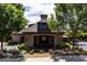 Community clubhouse surrounded by mature landscaping and flowers at 6042 Brookhaven Cir # 3202, Johns Creek, GA 30097