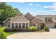 Beautiful home showcasing a well-maintained lawn, complemented by lush greenery and architectural details at 6042 Brookhaven Cir # 3202, Johns Creek, GA 30097