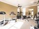 Well-equipped gym with treadmill, elliptical, weight machines, and ample natural light at 6042 Brookhaven Cir # 3202, Johns Creek, GA 30097