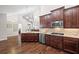 Open-concept kitchen with stainless appliances, dark cabinets, and access to living area at 6042 Brookhaven Cir # 3202, Johns Creek, GA 30097