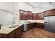 Gourmet kitchen featuring stainless steel appliances, granite counters, and dark wood cabinets at 6042 Brookhaven Cir # 3202, Johns Creek, GA 30097