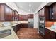 Gourmet kitchen featuring stainless steel appliances, granite counters, and dark wood cabinets at 6042 Brookhaven Cir # 3202, Johns Creek, GA 30097