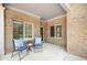 Cozy outdoor porch featuring brick accents, comfortable seating, and charming decor for relaxation at 6042 Brookhaven Cir # 3202, Johns Creek, GA 30097