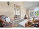 Relaxing sunroom with brick walls, tile floors, comfortable seating and vaulted ceilings at 6042 Brookhaven Cir # 3202, Johns Creek, GA 30097