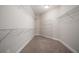 Walk-in closet with wire shelving and neutral carpet at 6042 Brookhaven Cir # 3202, Johns Creek, GA 30097