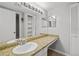 Bathroom featuring a white sink with granite countertops, multiple mirrors, and ample storage at 68 La Rue Nw Pl, Atlanta, GA 30327