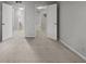 Spacious bedroom with neutral carpeting and two doorways leading to a bathroom and closet at 68 La Rue Nw Pl, Atlanta, GA 30327