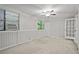 Spacious bedroom featuring neutral carpeting, paneled walls, windows, and a ceiling fan at 68 La Rue Nw Pl, Atlanta, GA 30327
