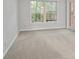 Bedroom featuring two windows with natural light and neutral carpet flooring at 68 La Rue Nw Pl, Atlanta, GA 30327