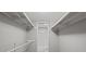 Walk-in closet with white shelving and a view into the adjoining bathroom at 68 La Rue Nw Pl, Atlanta, GA 30327