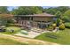 This image shows a beautifully landscaped clubhouse with meticulous stonework and an attached putting green at 68 La Rue Nw Pl, Atlanta, GA 30327