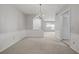 Spacious dining room with neutral walls, chandelier, and arched opening to another room at 68 La Rue Nw Pl, Atlanta, GA 30327