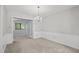 Bright dining area with neutral walls, chandelier, and French doors to a versatile space at 68 La Rue Nw Pl, Atlanta, GA 30327