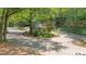 Gated community entrance surrounded by mature trees and landscaping at 68 La Rue Nw Pl, Atlanta, GA 30327