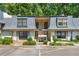 Charming townhouse with well-maintained landscaping, accessible parking, and covered entry, showcasing a cozy residential appeal at 68 La Rue Nw Pl, Atlanta, GA 30327