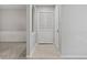 Bright hallway featuring neutral paint, tile flooring, and access to the living area and a coat closet at 68 La Rue Nw Pl, Atlanta, GA 30327