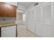 Kitchen view into dining area featuring tile floor and white cabinets at 68 La Rue Nw Pl, Atlanta, GA 30327