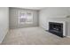 Living room featuring neutral walls, carpeting, a fireplace, and natural light from the window at 68 La Rue Nw Pl, Atlanta, GA 30327