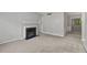 A spacious living room featuring neutral walls, carpeting, and a charming fireplace at 68 La Rue Nw Pl, Atlanta, GA 30327