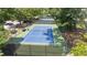 This image shows immaculately maintained tennis courts surrounded by lush greenery and fencing at 68 La Rue Nw Pl, Atlanta, GA 30327