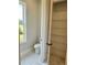 Modern half bathroom featuring sleek toilet, sink and storage at 7220 Winderlea Ln, Cumming, GA 30040