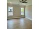 Bedroom featuring two windows and wood flooring at 7220 Winderlea Ln, Cumming, GA 30040