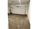 View of the garage featuring large garage door and concrete floor at 7220 Winderlea Ln, Cumming, GA 30040