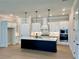 Bright, modern kitchen with a center island, stainless steel appliances, and ample cabinet space at 7220 Winderlea Ln, Cumming, GA 30040