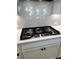 Modern kitchen featuring stainless steel gas cooktop with designer backsplash at 7220 Winderlea Ln, Cumming, GA 30040