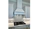 Modern kitchen featuring stainless steel appliances, custom cabinetry, and stylish backsplash at 7220 Winderlea Ln, Cumming, GA 30040