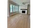 Spacious living room features wood floors, fireplace and many windows at 7220 Winderlea Ln, Cumming, GA 30040