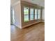 Bright living room features wood floors and multiple windows providing plenty of natural light at 7220 Winderlea Ln, Cumming, GA 30040