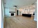Spacious living room featuring hardwood floors, fireplace and adjacent modern kitchen at 7220 Winderlea Ln, Cumming, GA 30040