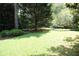 The backyard has well-manicured lawn with mature trees and foliage at 742 Starlight Ne Ct, Sandy Springs, GA 30342