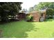 Well-maintained backyard featuring a brick home and cozy covered porch, perfect for outdoor relaxation at 742 Starlight Ne Ct, Sandy Springs, GA 30342