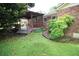 Charming backyard featuring a cozy covered porch, lush greenery, and landscaped details at 742 Starlight Ne Ct, Sandy Springs, GA 30342
