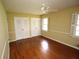 Bedroom featuring hardwood floors, a ceiling fan, and a large window at 742 Starlight Ne Ct, Sandy Springs, GA 30342