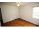 Bedroom featuring hardwood floors with natural light from a window and ceiling fan at 742 Starlight Ne Ct, Sandy Springs, GA 30342