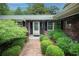 Charming front entrance with brick walkway, manicured shrubs, and decorative door at 742 Starlight Ne Ct, Sandy Springs, GA 30342