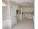 Bright eat-in kitchen featuring white cabinets, tiled floors, and charming floral wallpaper at 742 Starlight Ne Ct, Sandy Springs, GA 30342
