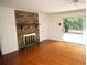 Inviting living room boasts a cozy brick fireplace and sliding glass doors to backyard at 742 Starlight Ne Ct, Sandy Springs, GA 30342