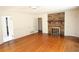 Spacious living room featuring a brick fireplace, hardwood floors and ample natural light at 742 Starlight Ne Ct, Sandy Springs, GA 30342