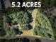 Aerial view of a 5.2 acre property surrounded by mature trees, offering privacy and seclusion at 1694 Herrington Rd, Lawrenceville, GA 30043