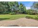 Spacious backyard featuring a stone patio and expansive green lawn at 4345 Mantle Ridge Dr, Cumming, GA 30041