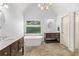 Bathroom features dual vanities and standalone tub with tile floors at 4345 Mantle Ridge Dr, Cumming, GA 30041