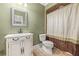 Traditional bathroom with decorative vanity, framed mirror, and coordinated tile and shower curtain at 4345 Mantle Ridge Dr, Cumming, GA 30041