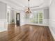 Formal dining room featuring hardwood floors, wainscoting, a decorative chandelier and plenty of light at 4345 Mantle Ridge Dr, Cumming, GA 30041
