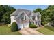 Charming two-story brick home with a well-manicured lawn, two-car garage and attractive shutters at 4345 Mantle Ridge Dr, Cumming, GA 30041